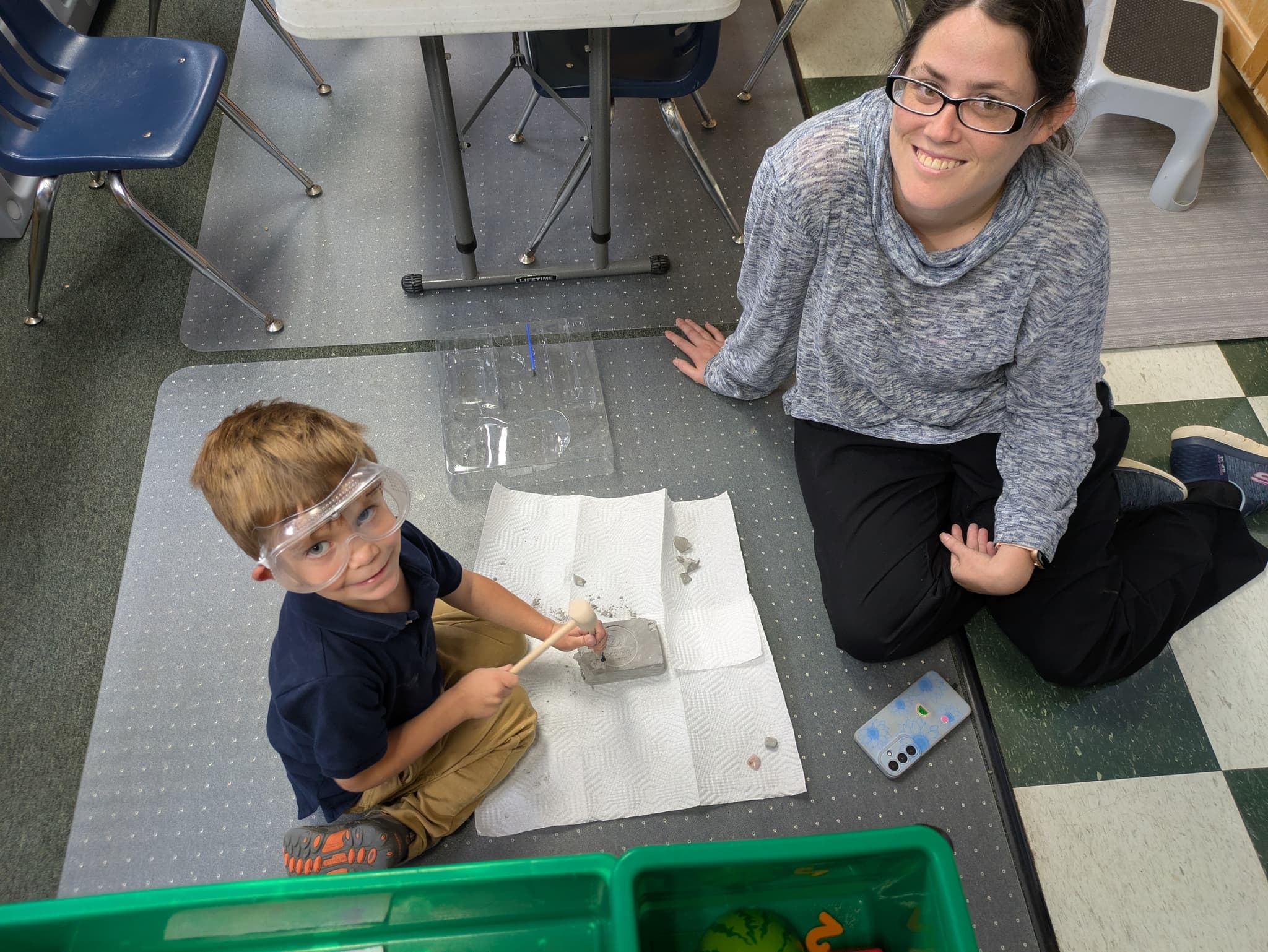 Preschooler doing a hands-on science experiment with teacher